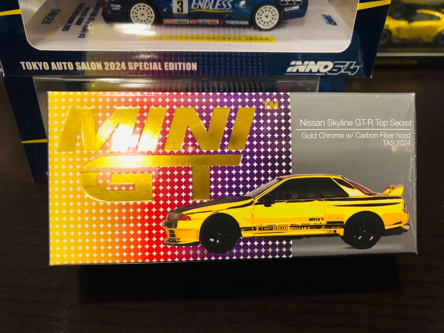 Mini GT Mini GT #671 Top Secret Nissan Skyline GT-R VR32 Gold Chrome w/ carbon fibre hood Tokyo Auto Salon 2024 Exclusive