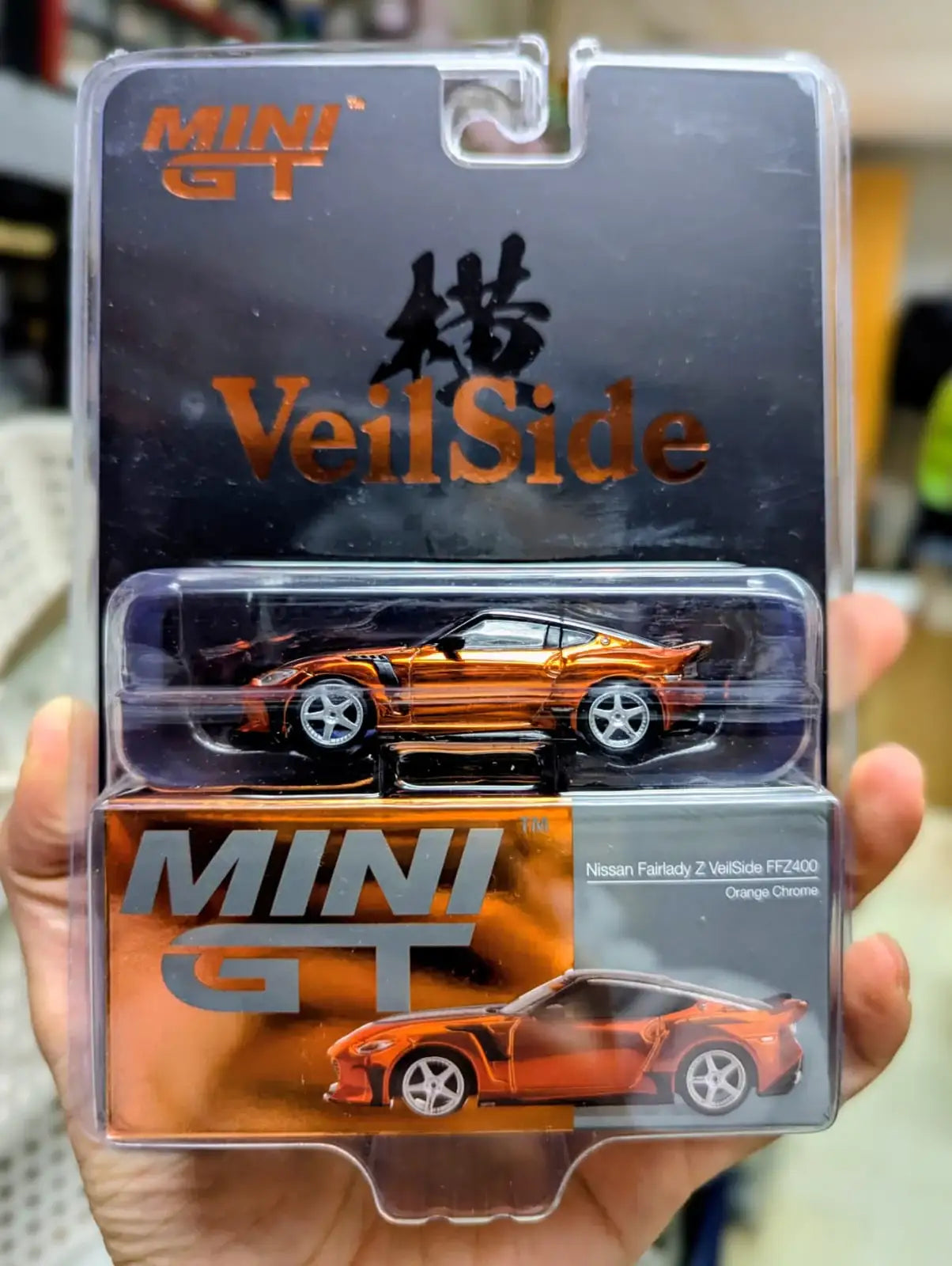 Mini GT Mini GT 1:64 Scale #1153 Nissan Z VeilSide FFZ400 Orange Chrome VeilSide Ltd. 2026 Exclusive with T-Shirt