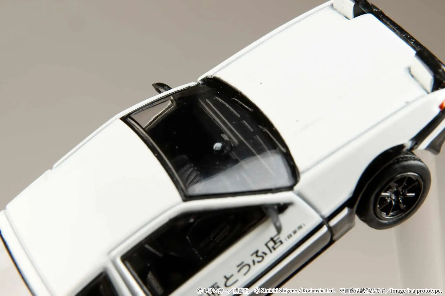 Hobby Japan 1:64 Toyota Sprinter Trueno AE86 model on a track.