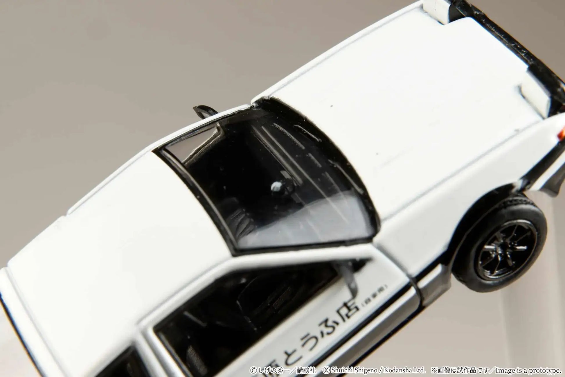 Hobby Japan 1:64 Toyota Sprinter Trueno AE86 model on a track.